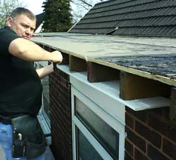 Fitting a new PVC-u soffit board to the eves of a house
