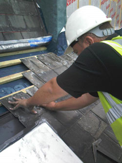Laying slates on a roof